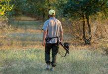 Ecco la data di apertura della caccia in Abruzzo data di apertura della caccia in Abruzzo: cacciatore di spalle con cane